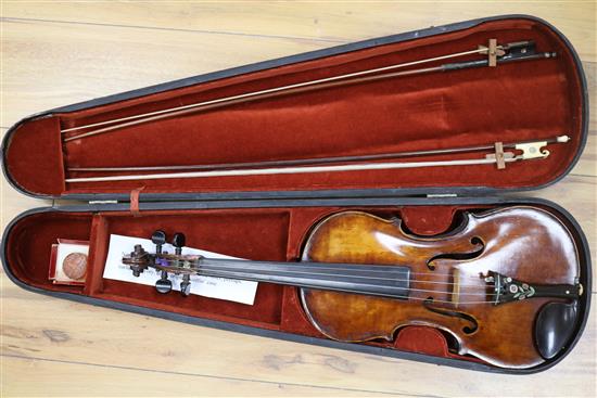A silver mounted violin bow, an ivory mounted violin bow and a late 19th century German violin, cased